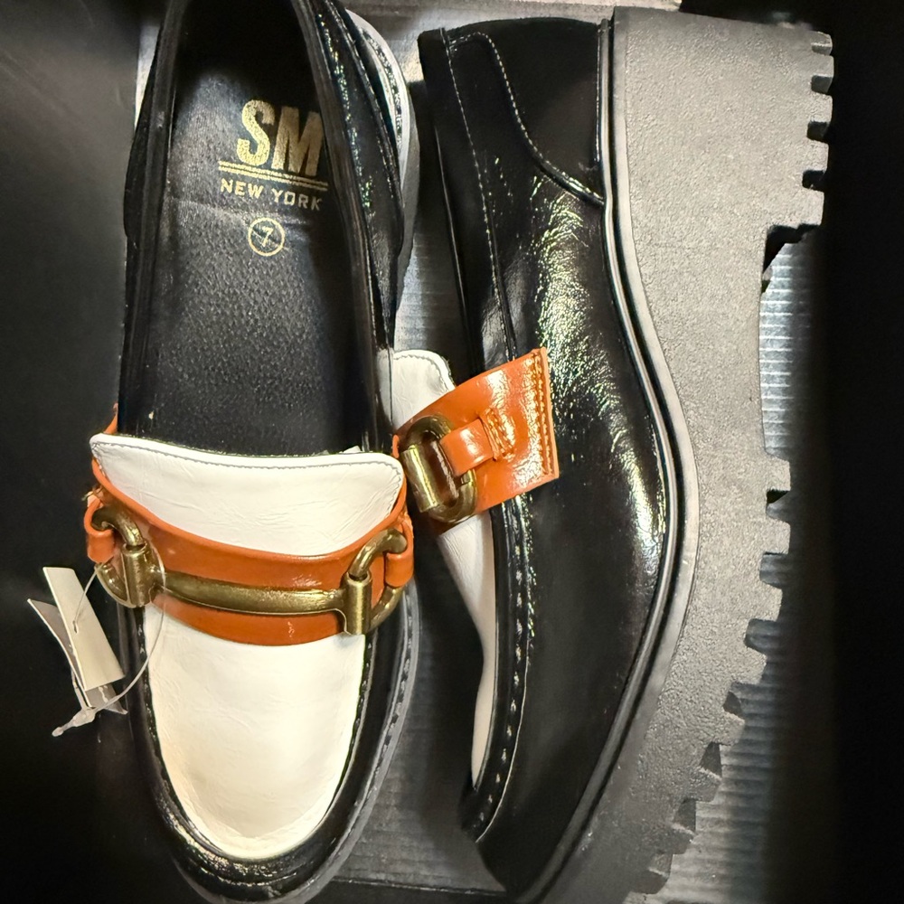 Stylish Black and White Loafers with Orange Accent